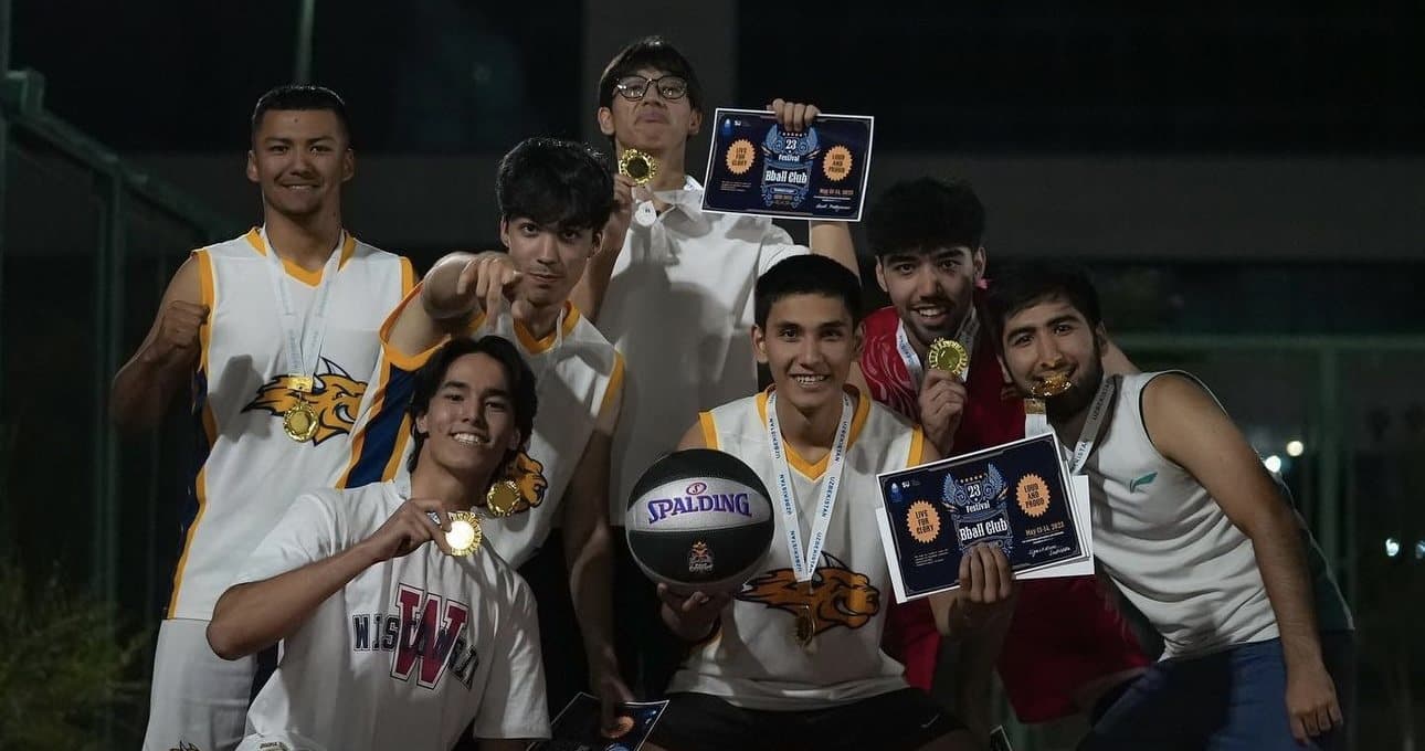 The Webster basketball team celebrating with medals