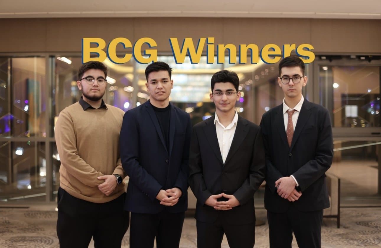 Four Webster students in suits under a BCG Winners sign
