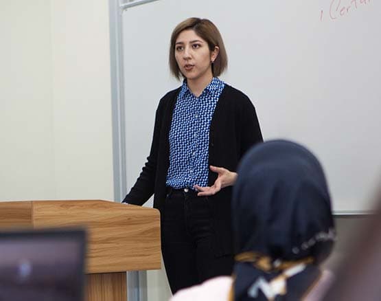 Webster Tashkent teacher lecturing in a classroom.