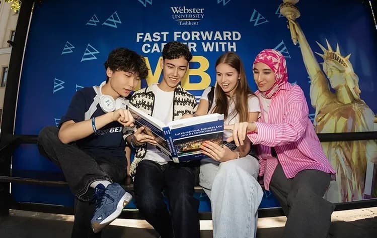Students happily talking about Webster at the bus stop