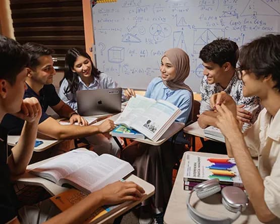 A female student is explaining something to three other students.